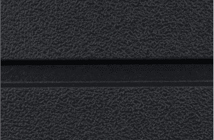 Close-up of a textured, dark gray surface with a black horizontal groove running across the middle. The surface features a slightly rough, pebbled pattern.