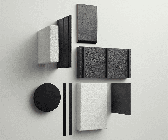 A minimalist wall arrangement features geometric shapes in black and white, including rectangles, a circle, and thin lines, all with varied textures on a light gray background.