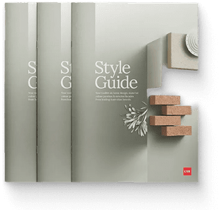 Three copies of a book titled "Style Guide" with a minimalist cover design, featuring geometric shapes and a sprig of greenery on a muted, light-gray background.